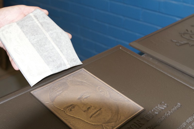 Hand rubbed, dark oxide stain on the photo relief adds texture, depth, and character to the portrait