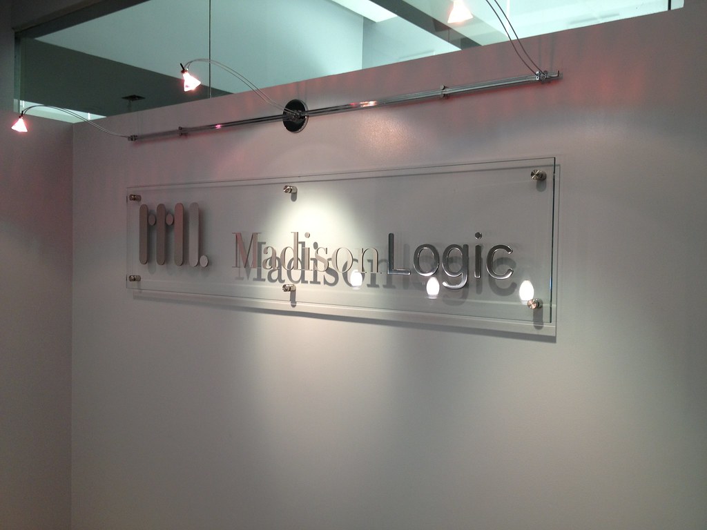 Clear Glass Panel Sign with Brushed and Polished Metal Logo applied to face