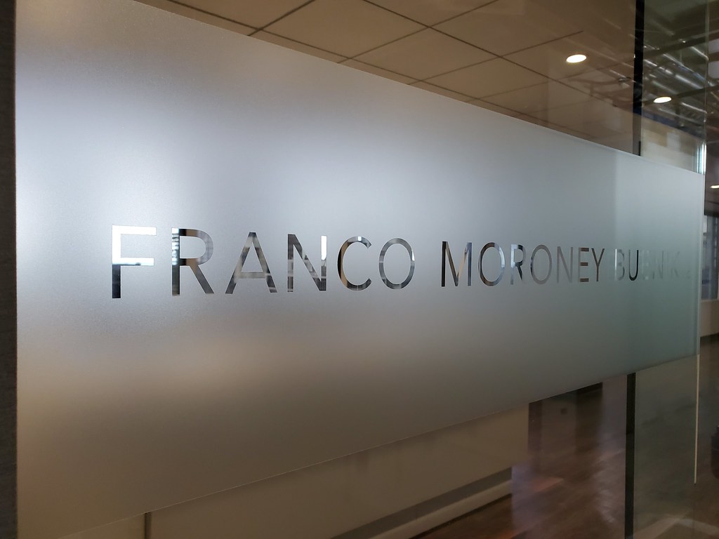 Etched look vinyl decal with reverse cut lettering for interior office glass partition